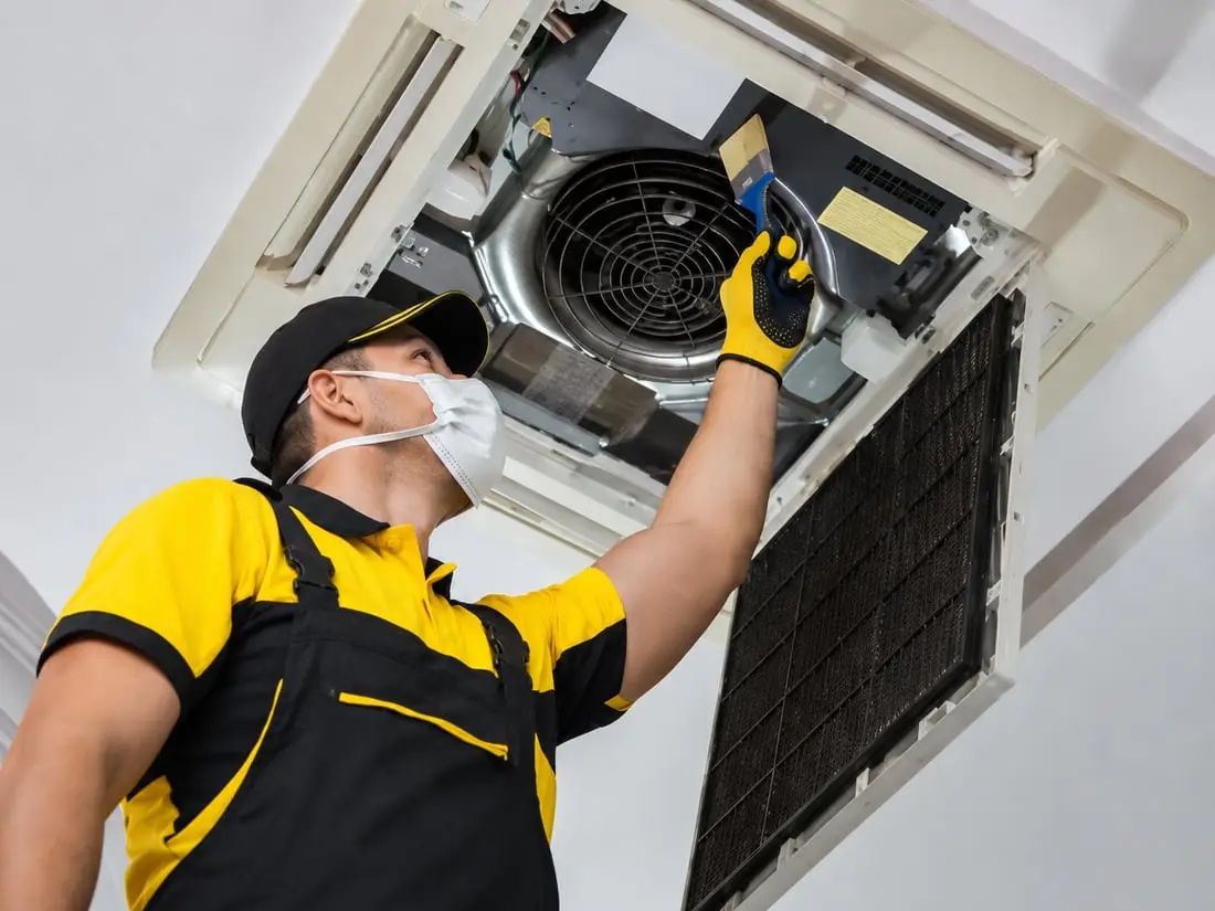 HVAC technician installing air conditioning unit in Sarasota FL — Sunrise Contractors