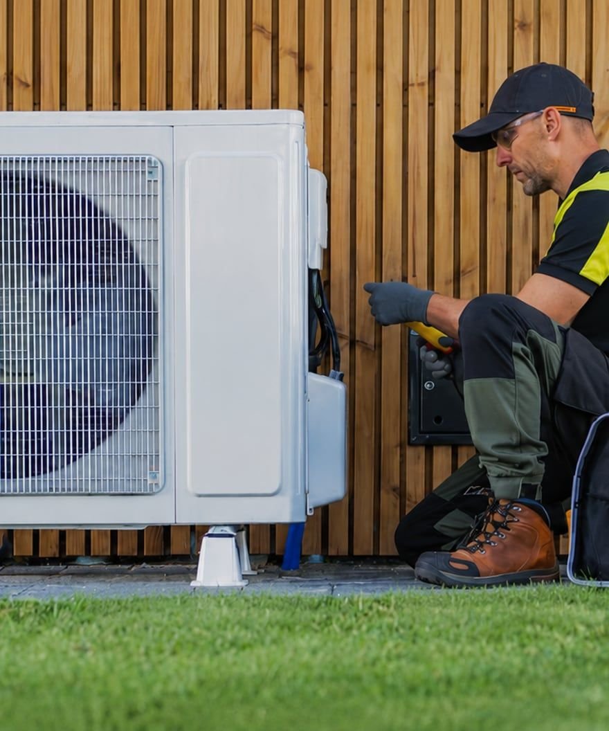 Licensed HVAC technician servicing air conditioning system in Sarasota FL — Sunrise Contractors