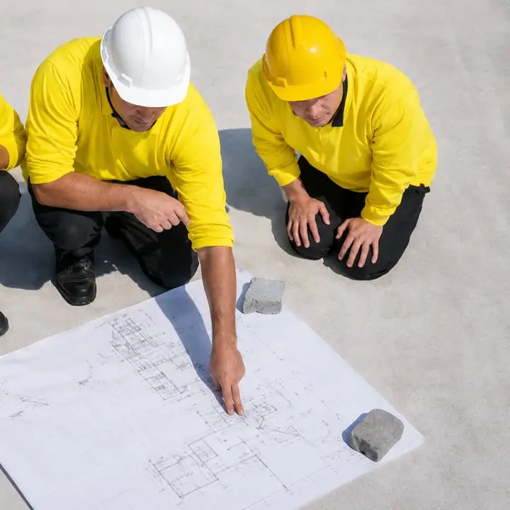 Construction team reviewing blueprints — Sunrise Contractors Sarasota FL
