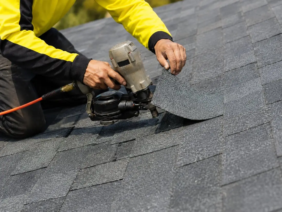 Roofer installing asphalt shingles in Sarasota FL — Sunrise Contractors
